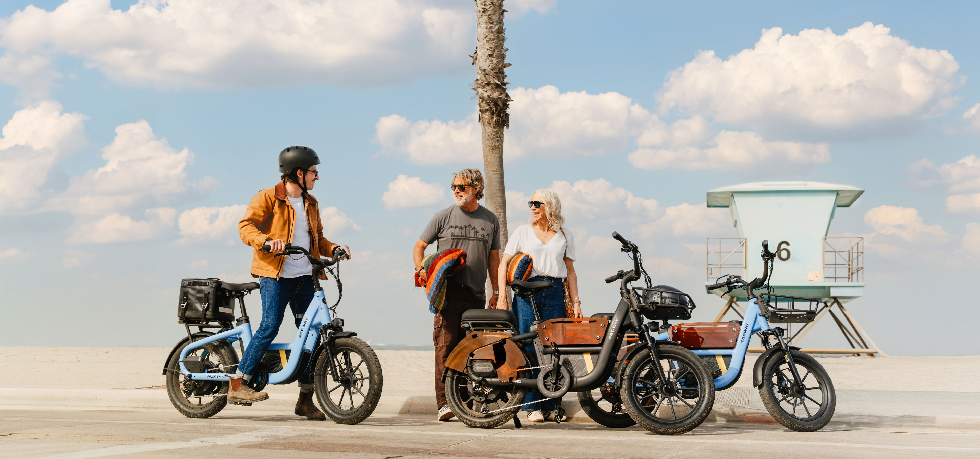 Segway MUXI Pro bikes on a sunny beach boardwalk