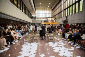 After the show was over, all the influencers and models lined up for one last photo. Shown on the ground was the runway outlined with loose leaf paper.