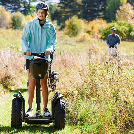Segway i2se with woman moving through field